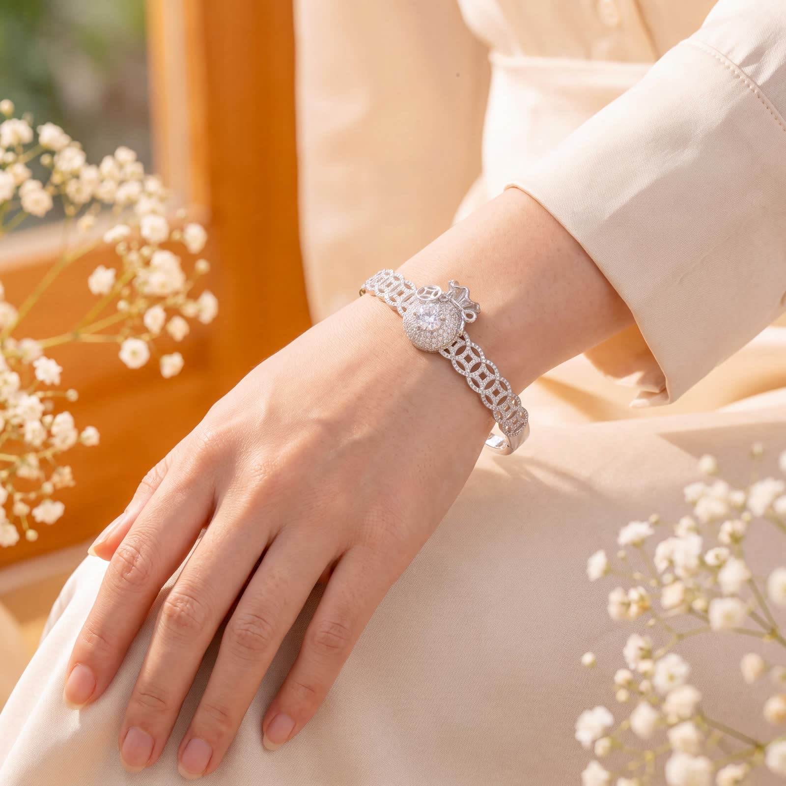 Coin and Money Bag Bangle Bracelet in Platinum-Plated Silver - worn on the wrist