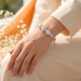 Three Stone Floral Halo Moissanite Bangle in Platinum-Plated Silver - worn on the wrist