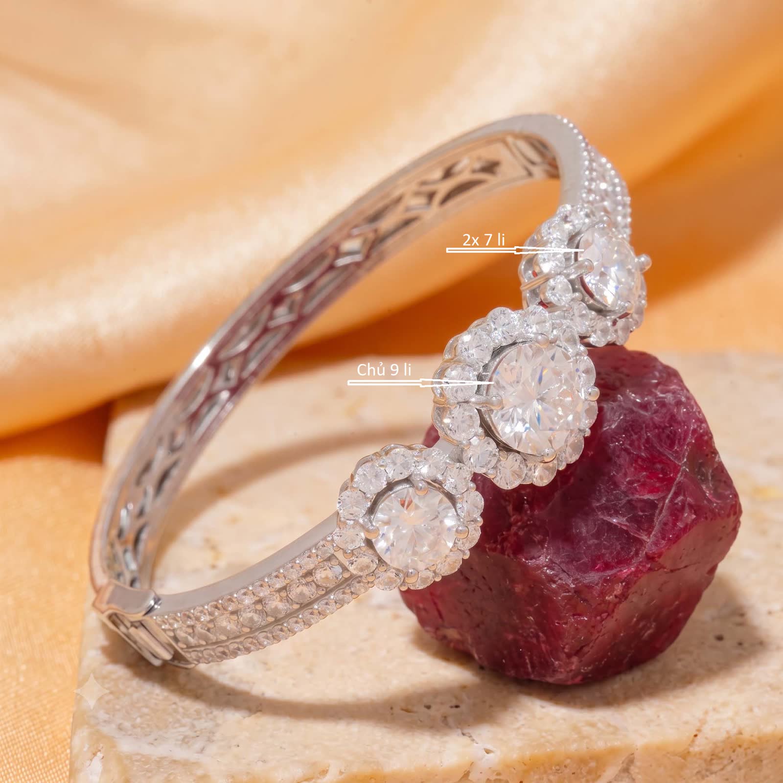 Three stone floral halo bangle with supplier labels showing one 9 mm center and two 7 mm side stones