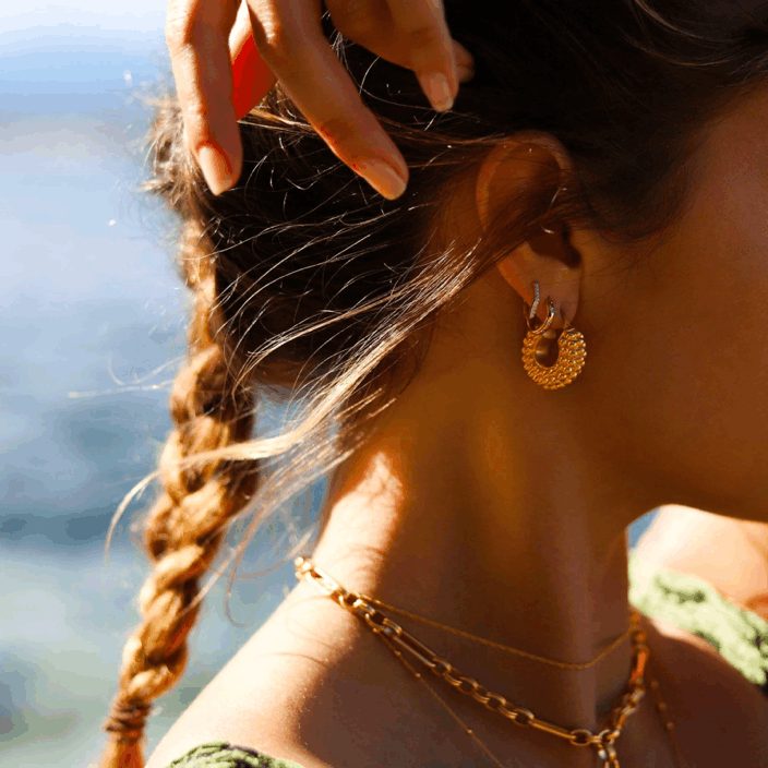 Gold hoop earring and chain necklace